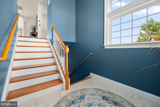 stairs featuring tile patterned floors