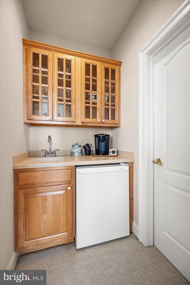 kitchen featuring light colored carpet, sink, and white refrigerator