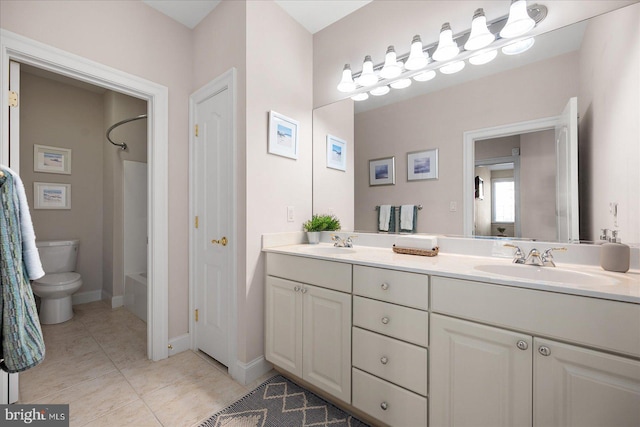 full bathroom with toilet, vanity, tile patterned floors, and washtub / shower combination