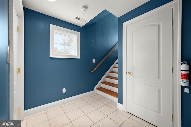 stairway with tile patterned flooring