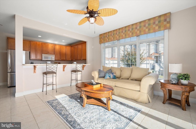 living room featuring light tile patterned flooring and ceiling fan