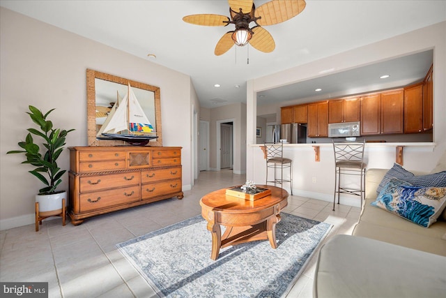 living room featuring ceiling fan and light tile patterned floors