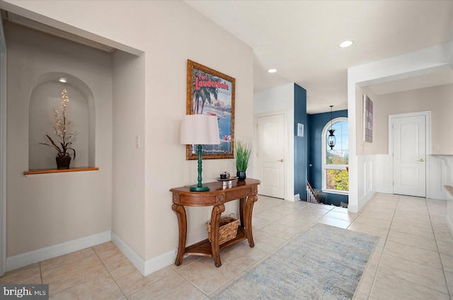 hall featuring light tile patterned floors