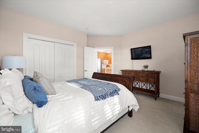 carpeted bedroom featuring stainless steel fridge and a closet