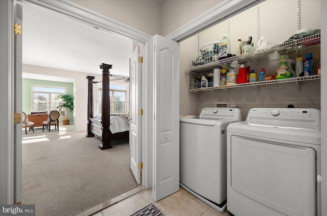 laundry area with washing machine and clothes dryer and light colored carpet