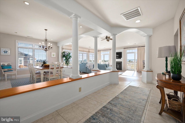 kitchen with light tile patterned floors, decorative light fixtures, and ceiling fan with notable chandelier