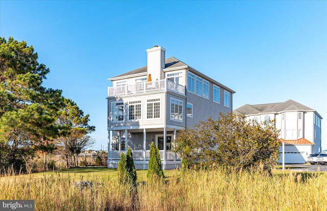 back of property with a balcony