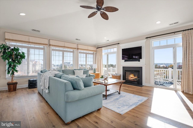 living room featuring light wood-type flooring and ceiling fan