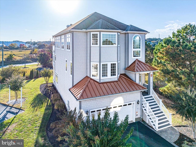 view of front of home featuring a garage and a front lawn