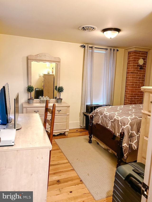 bedroom with visible vents and light wood-style floors