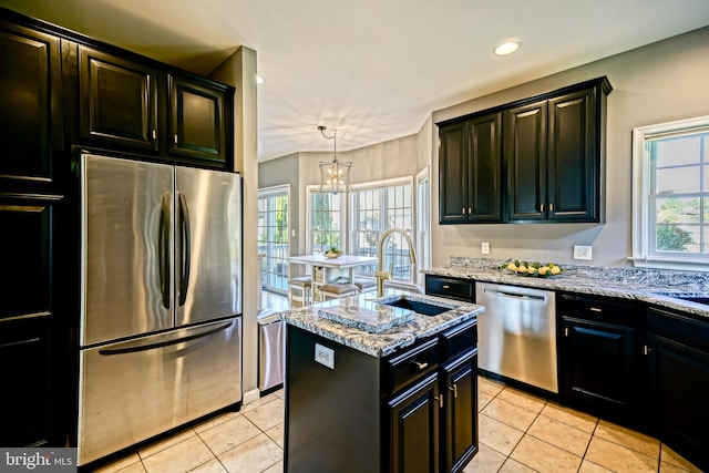 kitchen with a healthy amount of sunlight, decorative light fixtures, sink, and stainless steel appliances