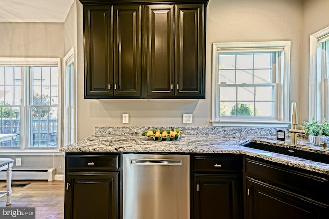 kitchen featuring light hardwood / wood-style floors, dishwasher, light stone countertops, and sink