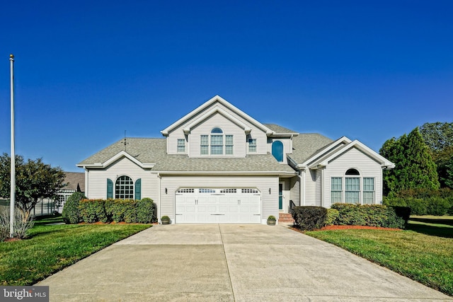 traditional home with an attached garage, a shingled roof, driveway, and a front lawn