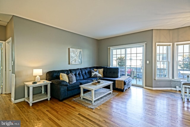 living area with wood finished floors and baseboards