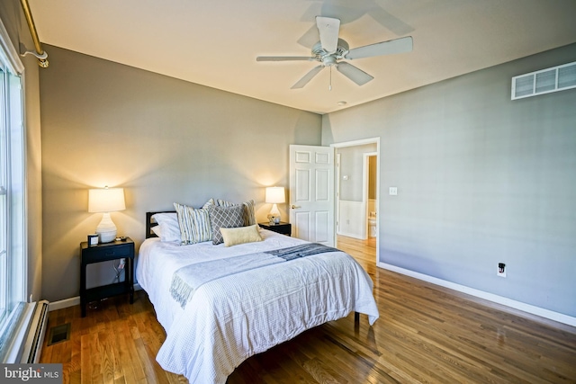 bedroom featuring visible vents, baseboards, a ceiling fan, and wood finished floors