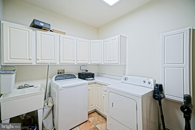 washroom with washer and dryer, cabinets, light tile patterned floors, and sink