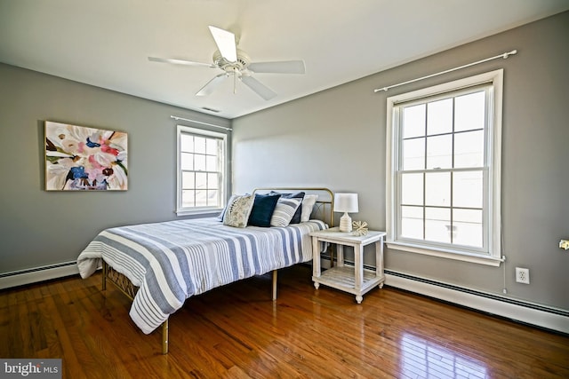 bedroom featuring a baseboard radiator, a ceiling fan, and wood finished floors