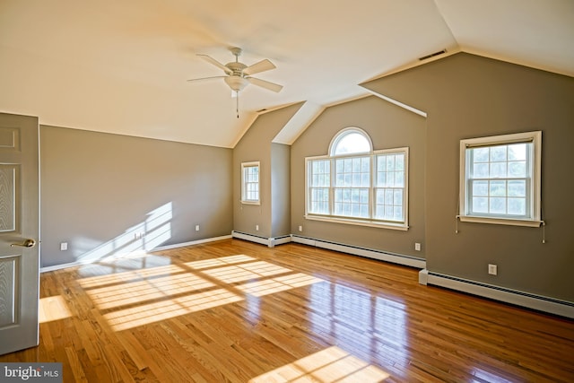 empty room with ceiling fan, light wood-type flooring, and plenty of natural light