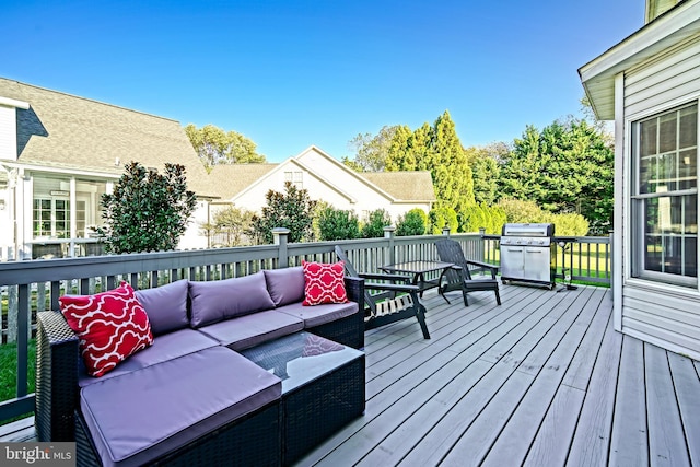 wooden deck featuring an outdoor living space and a grill