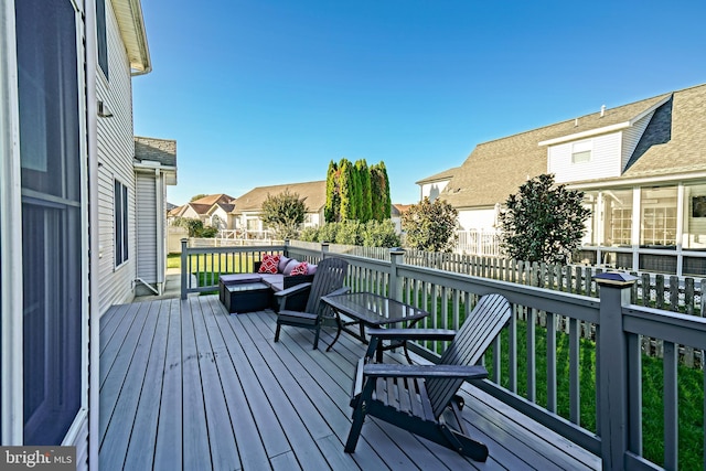 wooden terrace featuring an outdoor living space