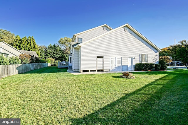 back of property with a lawn