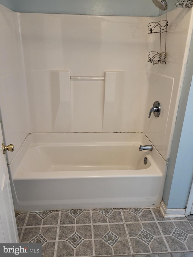 full bathroom with tile patterned flooring and washtub / shower combination