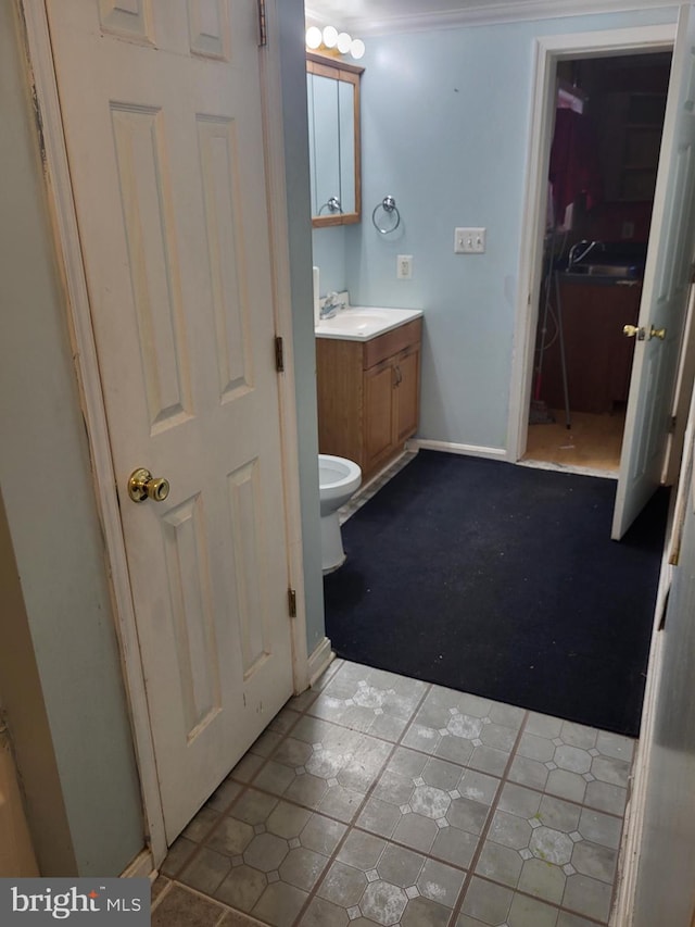 bathroom with vanity and baseboards