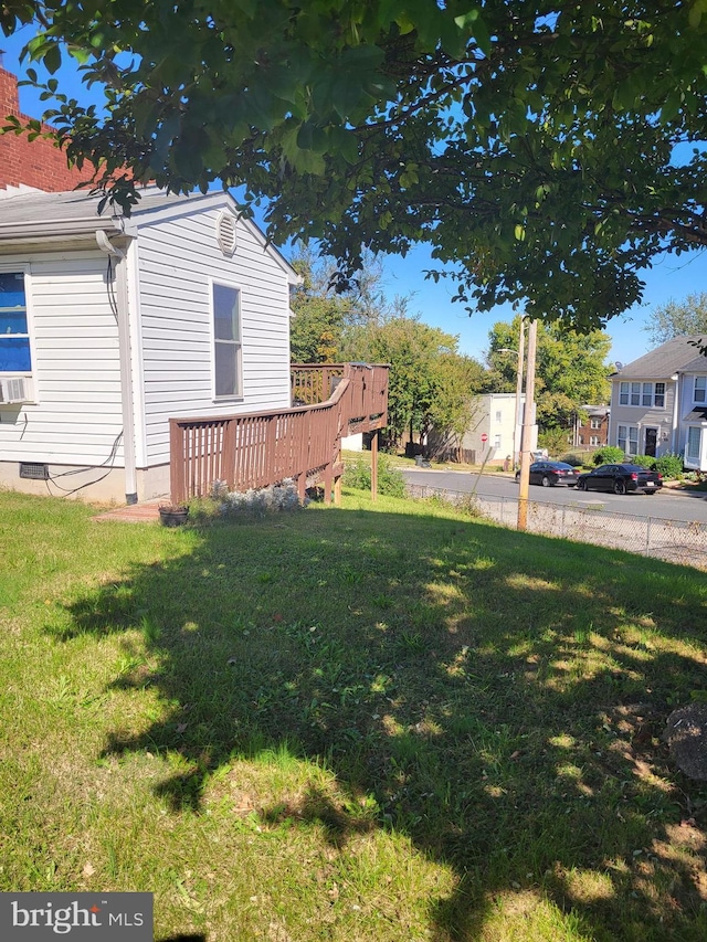 view of yard with cooling unit and a wooden deck