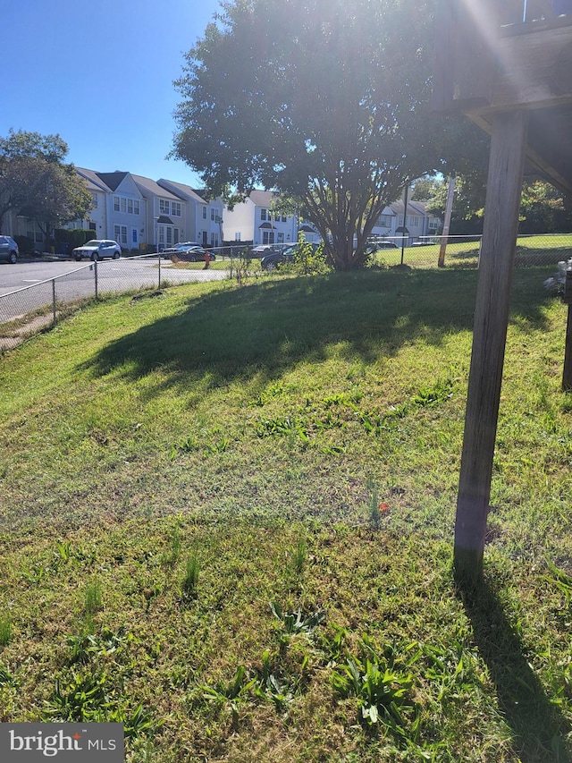 view of yard with a residential view and fence