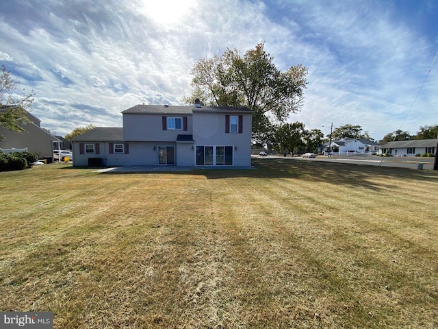 back of house with a yard