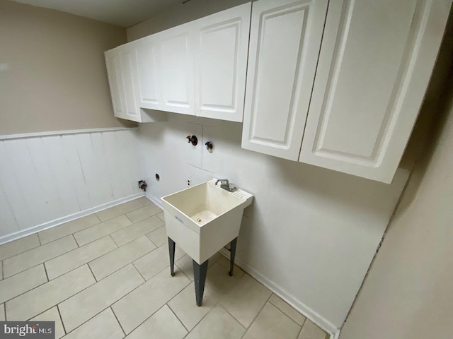 washroom with hookup for a washing machine, cabinets, light tile patterned floors, and electric dryer hookup