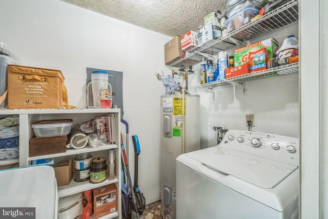 washroom with washer / dryer, electric water heater, and a textured ceiling