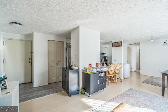 kitchen featuring a textured ceiling and hardwood / wood-style flooring