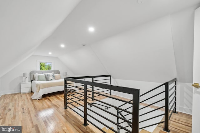 bedroom featuring hardwood / wood-style floors and vaulted ceiling