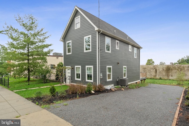 view of side of home with central AC