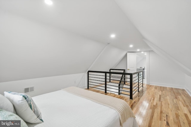 bedroom featuring light hardwood / wood-style flooring and vaulted ceiling