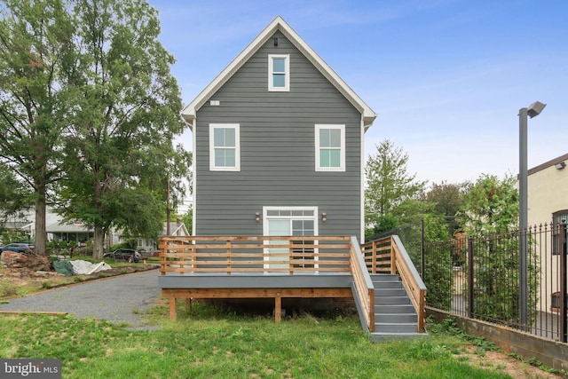 rear view of house featuring a deck