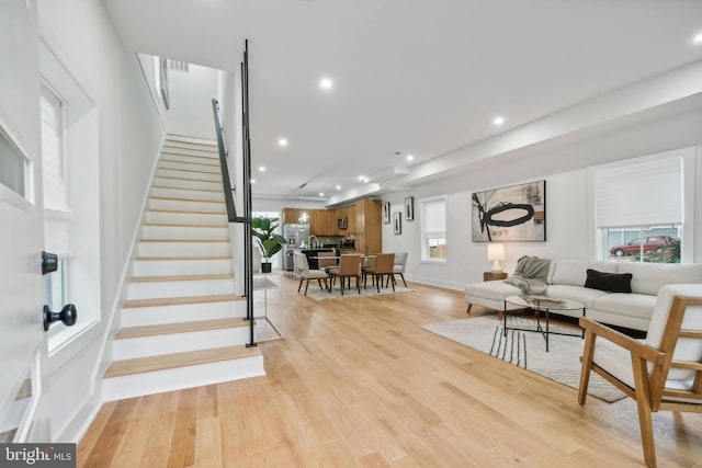 living room featuring light wood-type flooring and plenty of natural light