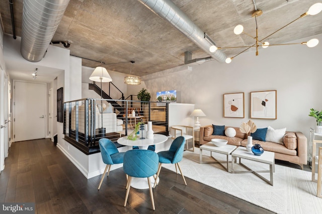 dining space with a notable chandelier and dark hardwood / wood-style floors