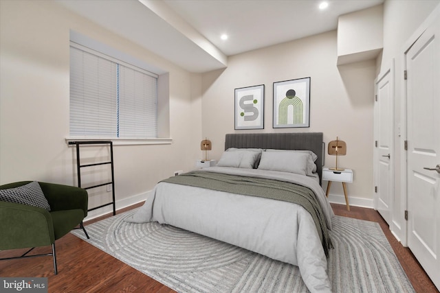 bedroom with dark hardwood / wood-style flooring