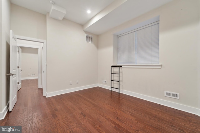 empty room featuring dark wood-type flooring