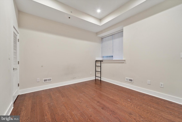 spare room with wood-type flooring