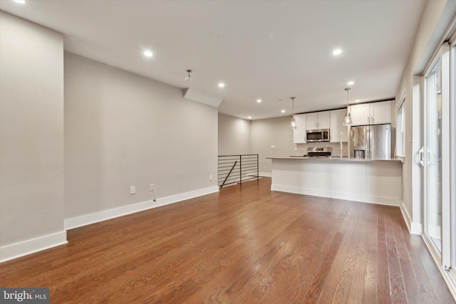 unfurnished living room with hardwood / wood-style flooring