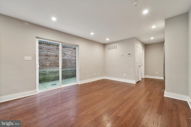 empty room featuring dark hardwood / wood-style flooring