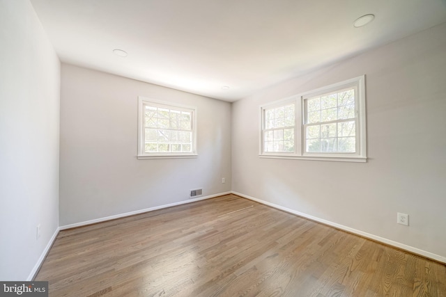 empty room with light hardwood / wood-style floors