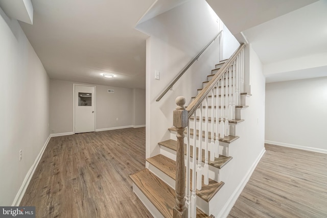 stairway featuring hardwood / wood-style floors