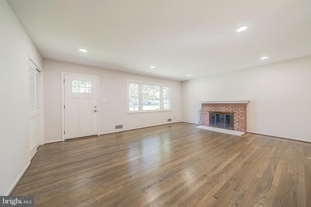 unfurnished living room with dark hardwood / wood-style floors and a fireplace