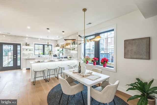 dining room with sink and light wood-type flooring