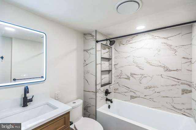 full bathroom with tiled shower / bath combo, vanity, and toilet