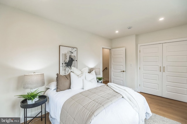 bedroom with a closet and light wood-type flooring